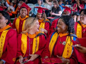 nursing graduates smiling at commencement